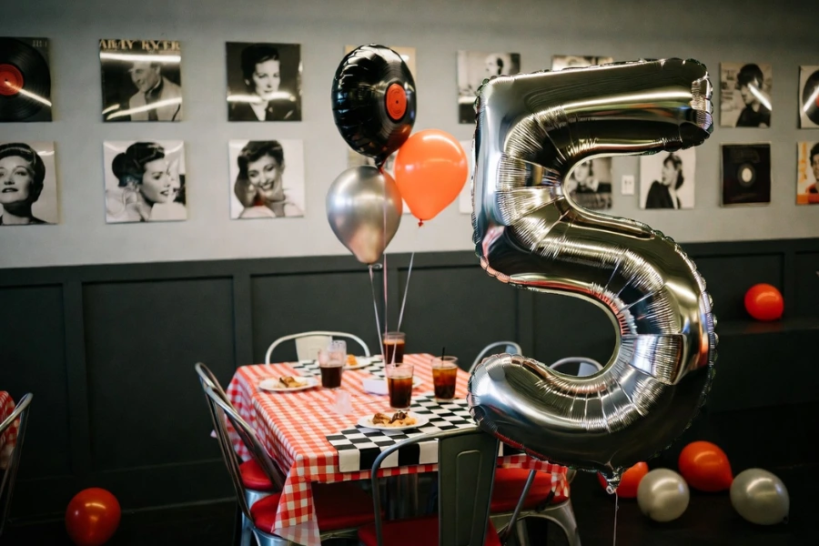 50s themed party decorations wholesale setup with diner balloons and retro tableware