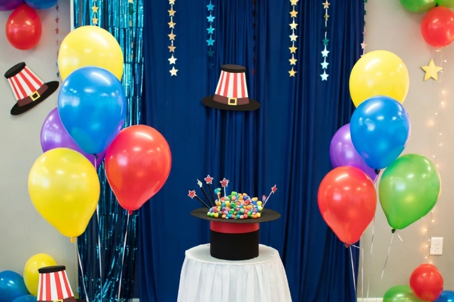magic themed party decorations with balloons banners and magician props