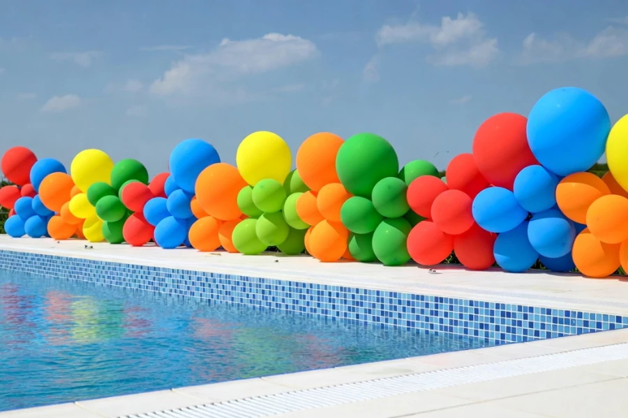 Poolside balloon decoration using air-filled latex and foil balloons in outdoor event
