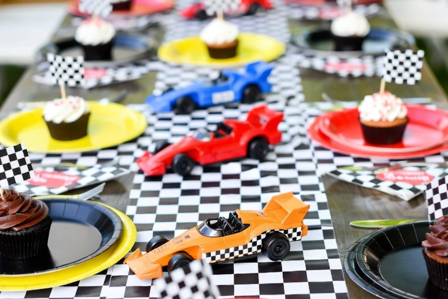 race car birthday table decorations with checkered runner and toy car centerpieces