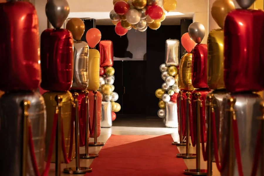 red carpet birthday party entrance with balloons and luxury decor